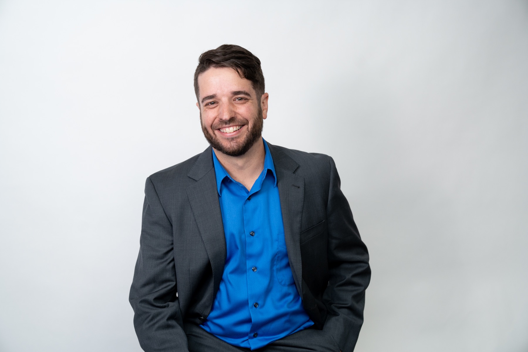 Portrait of Travis Cournoyer in a dark jacket.