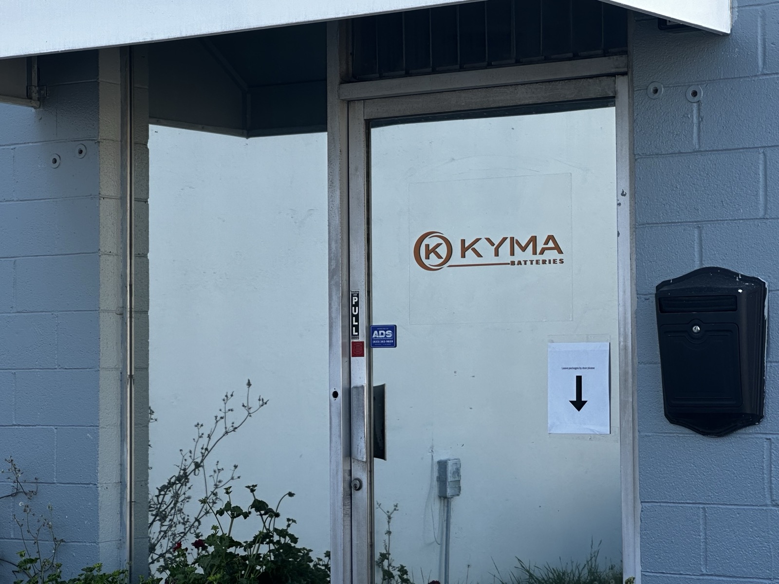 Kyma logo on the front door of the company headquarters.